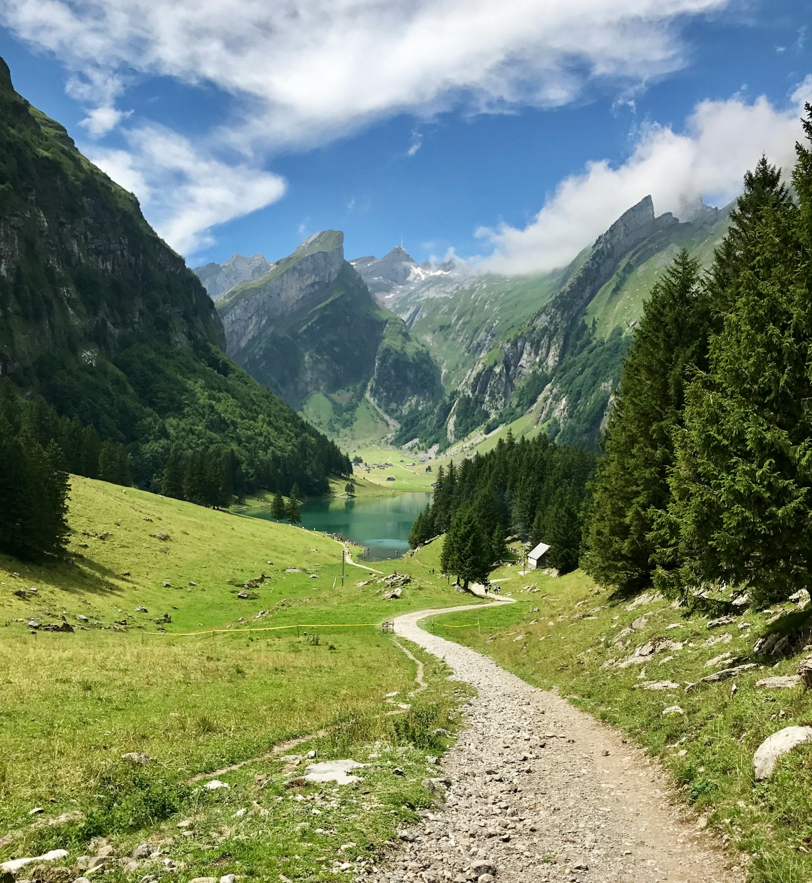 Trail leading down to the turquoise Seealpsee lake in the Alpstein mountains