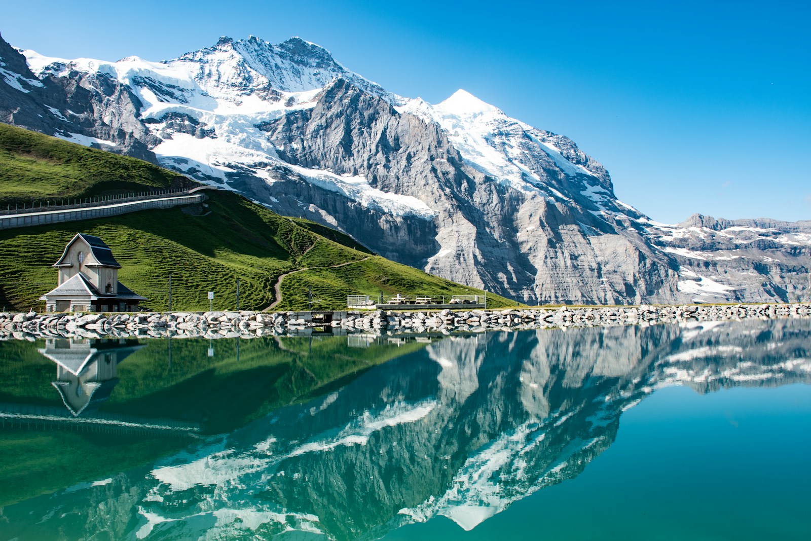 Snow-capped Jungfrau reflected in a mirror-calm mountain lake near Grindelwald